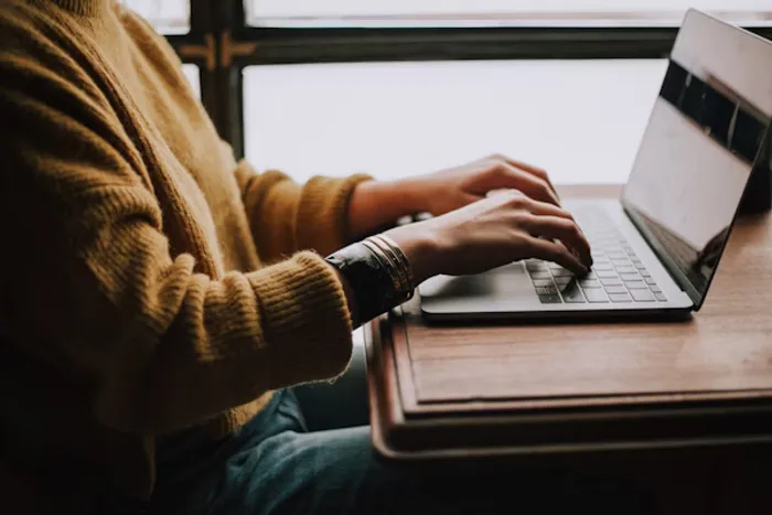 person sitting at a keyboard